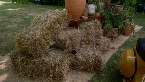 Straw Bale Seating On Jute Runner With Terracotta Pots In Garden Stock Footage 342859728