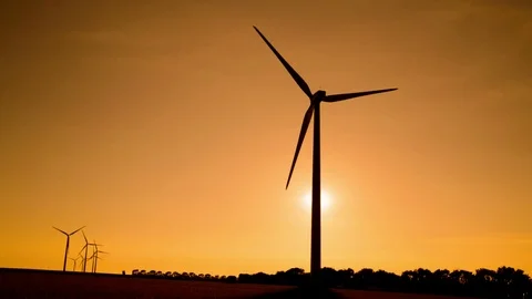 Straw ball in a field with wind farm in background	 Video stock 99003579
