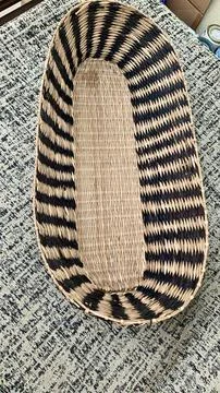 Straw basket on a striped surface Stock Photos