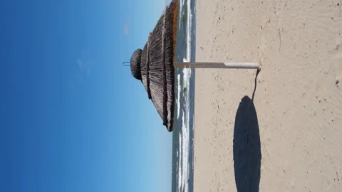 Straw beach rattan parasol at the empty beach with blue sky backgrounds sea 動画素材 247154912