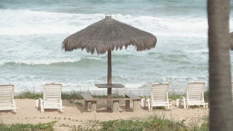 Straw beach umbrella and deck chairs on the tropical beach 스톡 동영상 128093788
