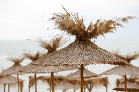 Straw beach umbrellas Stock Photos