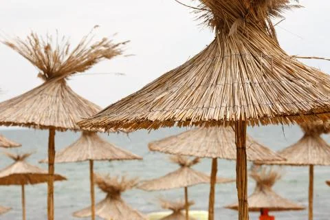 Straw beach umbrellas Stock Photos