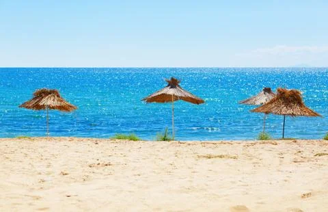 Straw beach umbrellas Stock Photos