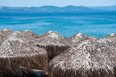 Straw beach umbrellas Stock Photos