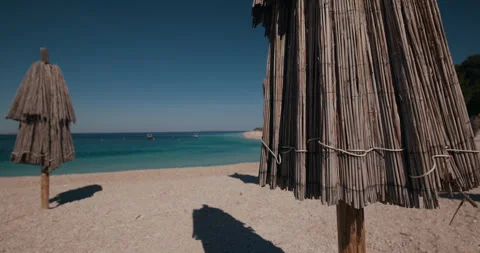Straw Beach Umbrellas on Primosten Shore Video stock 336928632