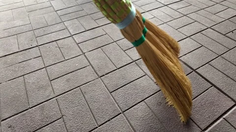 Straw broom. broom in hands. man sweeps floor with broom. slow motion video. Stock Footage 304317812