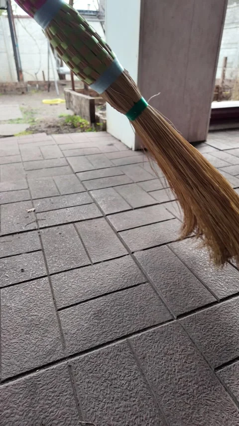 Straw broom. broom in hands. man sweeps floor with broom. slow motion video. Stock Footage 304317814