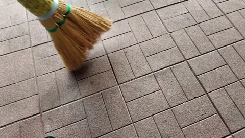 Straw broom. broom in hands. man sweeps floor with broom. slow motion video. Stock Footage 304317820