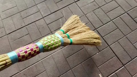 Straw broom. broom in hands. man sweeps floor with broom. slow motion video. Stock Footage 304317821