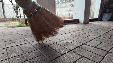 Straw broom. broom in hands. man sweeps floor with broom. slow motion video. Stock Footage 304317854