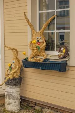 Straw bunny by the window as decor for Easter. Фото