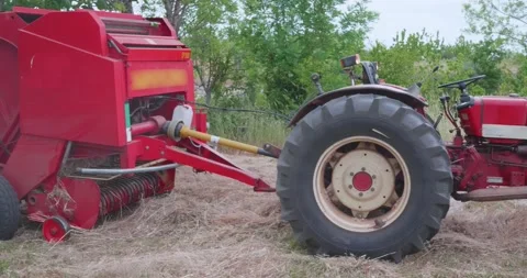 Straw collection after wheat harvests. Hay Tools In Action Farmers tractor pu Video stock 154402706