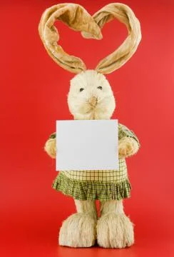 Straw hare on a red background . Stock Photos