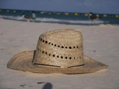 Straw hat at the beach Stock Photos