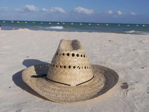 Straw hat at the beach Stock Photos