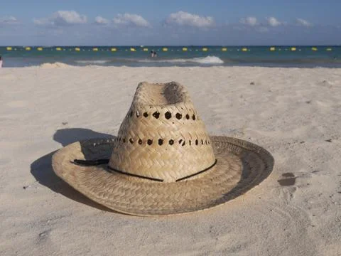 Straw hat at the beach Stock Photos
