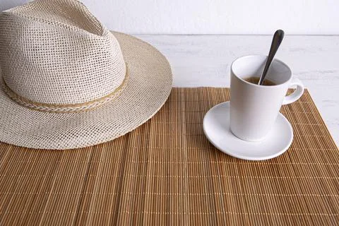 Straw hat with a cup of coffee  Stock Photos