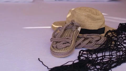 Straw hat, flip-flops, and cocktail glass: essentials for seaside resorts, beach Stock Footage 270084933