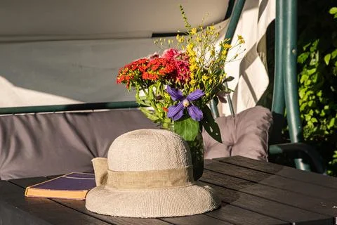 Straw hat on a garden table Stock Photos
