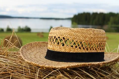 Straw hat on a haystack in a field close-up. Summer mood Fotos Stock