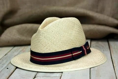 Straw hat on rustic surface Stock Photos
