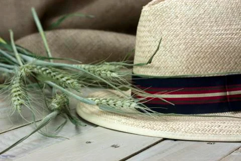 Straw hat on rustic surface Stock Photos