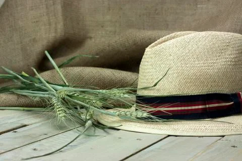Straw hat on rustic surface Stock Photos