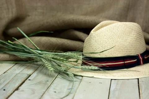 Straw hat on rustic surface Stock Photos