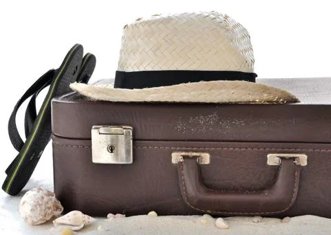 Straw hat in a suitcase Stock Photos