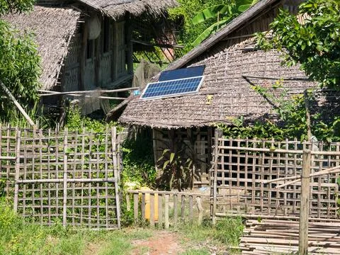 Straw house with solar panel Stock Photos