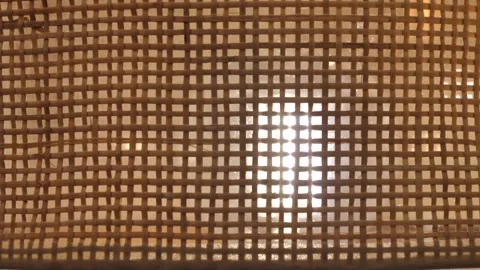 Straw lampshade background, wiring in a circle from left to right, glowing .. Stock Footage 297817204