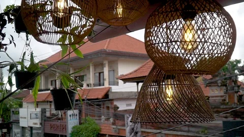 A straw lampshade hanging rotates in the background of a Bali Ubud house 库存影片 126969703