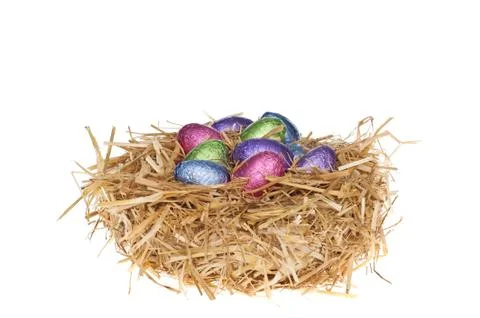 Straw nest with chocolate easter eggs Stock Photos