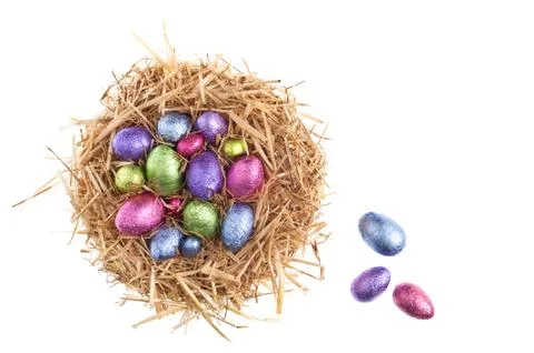 Straw nest with chocolate easter eggs Stock Photos