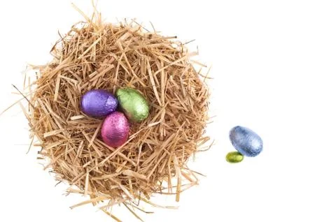 Straw nest with chocolate easter eggs Stock Photos