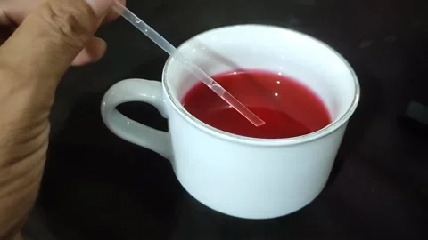 Straw for stirring red drink in cup Stock Footage 287692931