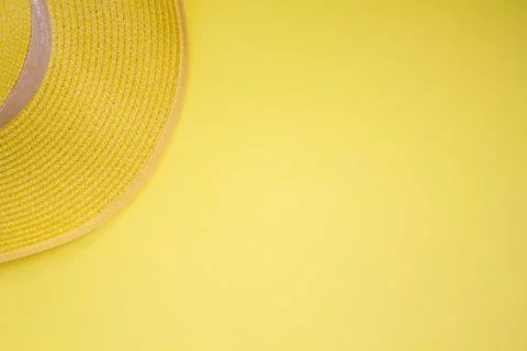 Straw summer hat on yellow background. Top view with copy space Stock Photos