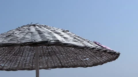 Straw umbrella on the beach Stock Footage 246009621