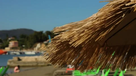 A straw umbrella on the beach in the wind. Stock Footage 199611515