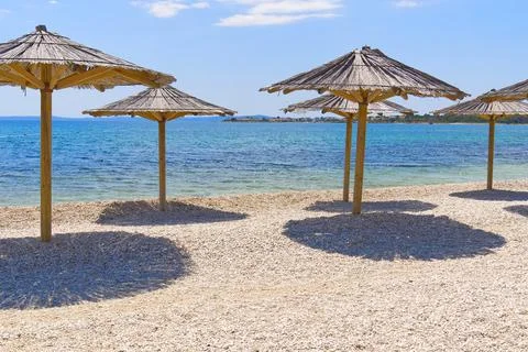 Straw umbrellas on the beach. Empty beaches during quarantine. luxury beach Foto stock