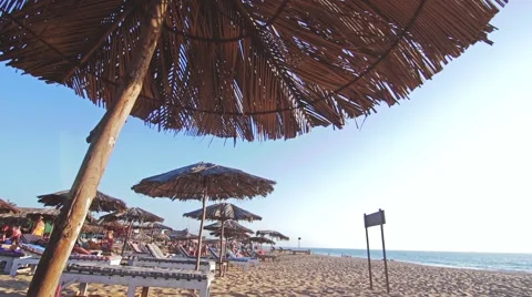 Straw umbrellas on the ocean coast Video stock 59794582