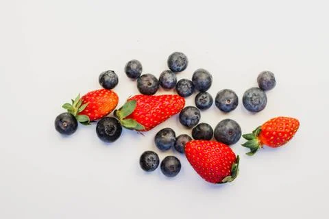 Strawberries and blueberries on a white background Stock Photos