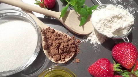 Strawberries and cocoa on a baking dish with mint and honey Stock Footage 90373321
