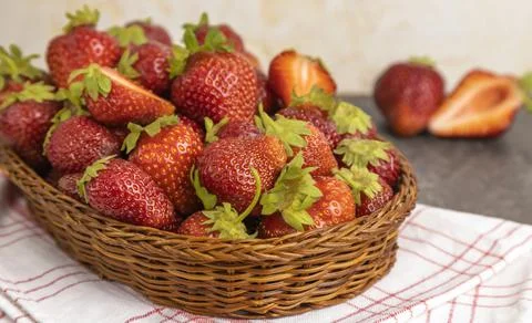 Strawberries in a basket on the table. Close up. Stock Photos