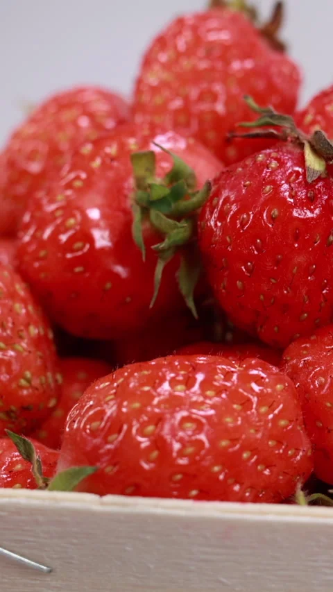 Strawberries in basket on white background, smooth slider motion. Vertical Stock Footage 334658249