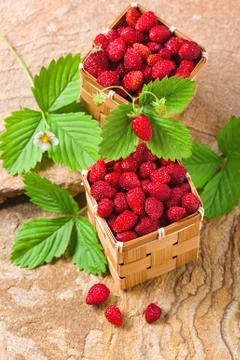 Strawberries in a baskets on a stone Fotos de archivo