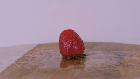 Strawberries being dropped while Rotating over white background Vídeos de archivo 127985450