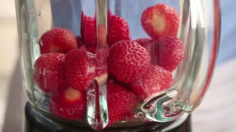 Strawberries being pureed in a blender Stock Footage 24657779