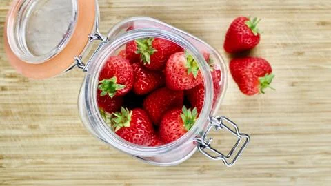 Strawberries in big kitchen jar Stock Photos
